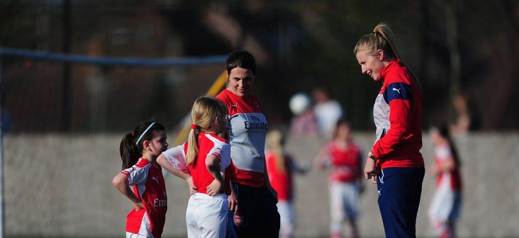 Professional female footballers meeting with young fans