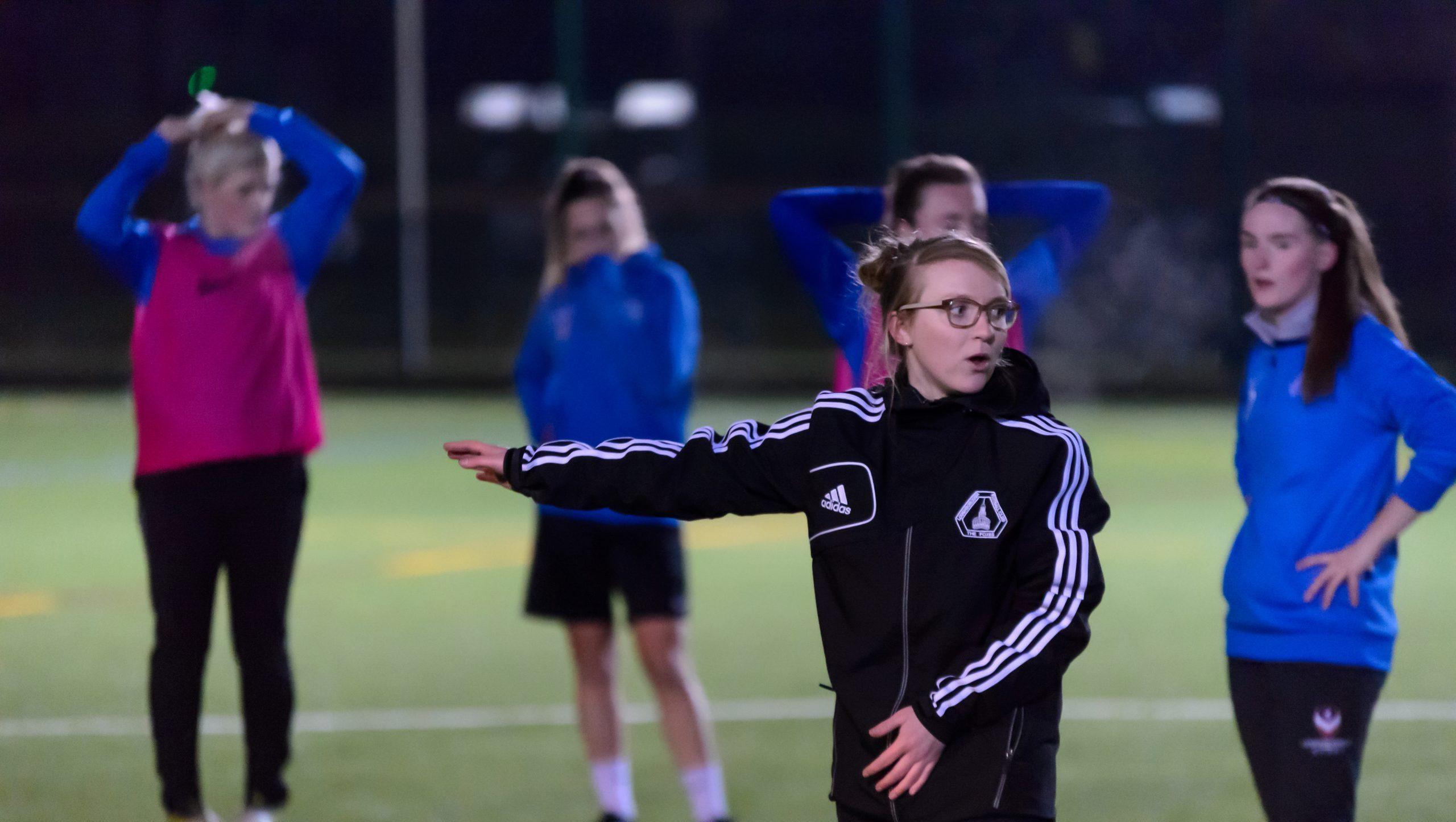 Woman coaching a football session