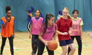 A group of girls playing basketball