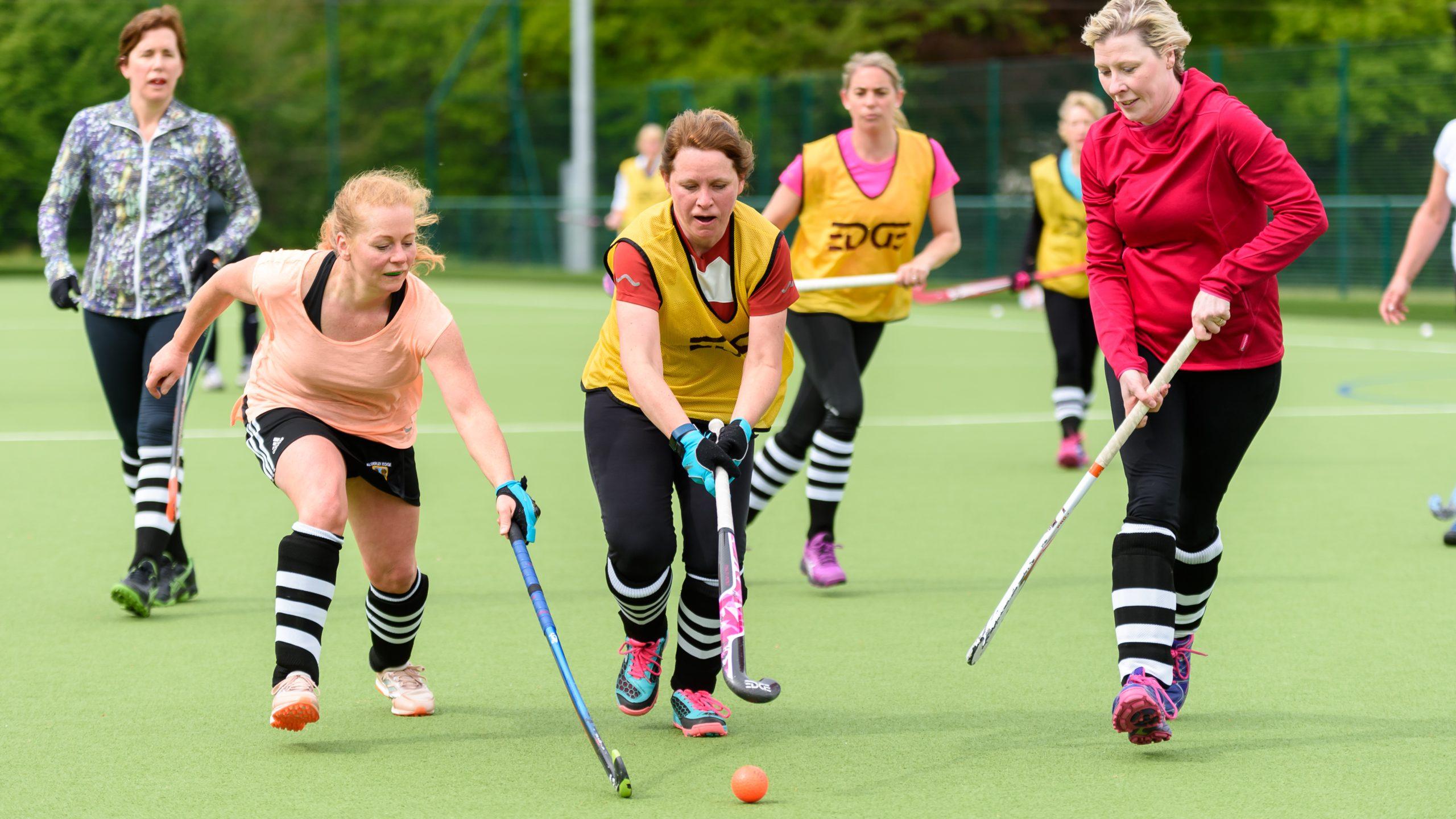 A group of women aged 40-50 playing hockey