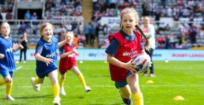 Young girls playing Rugby