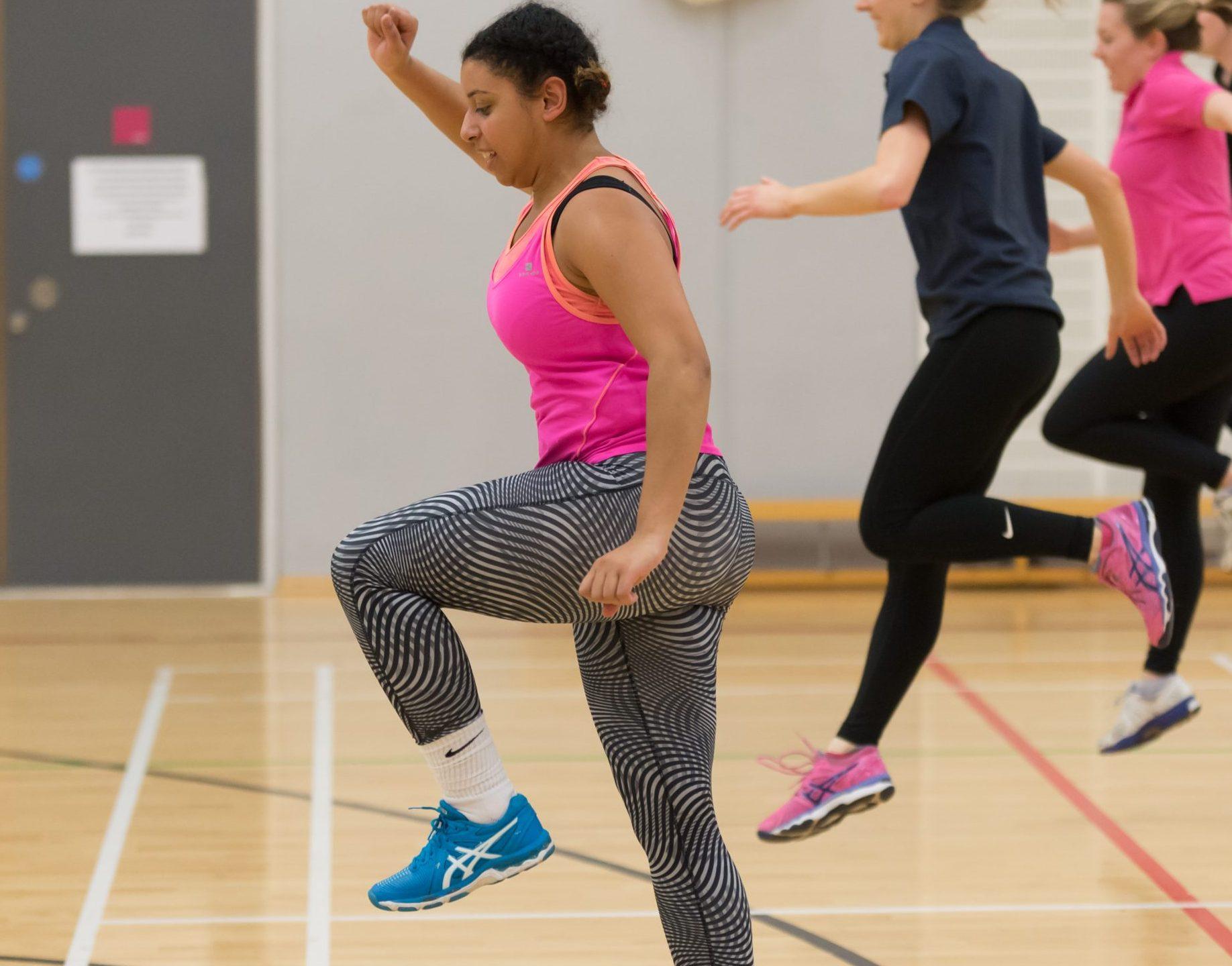 Group of female university students exercising in a gym