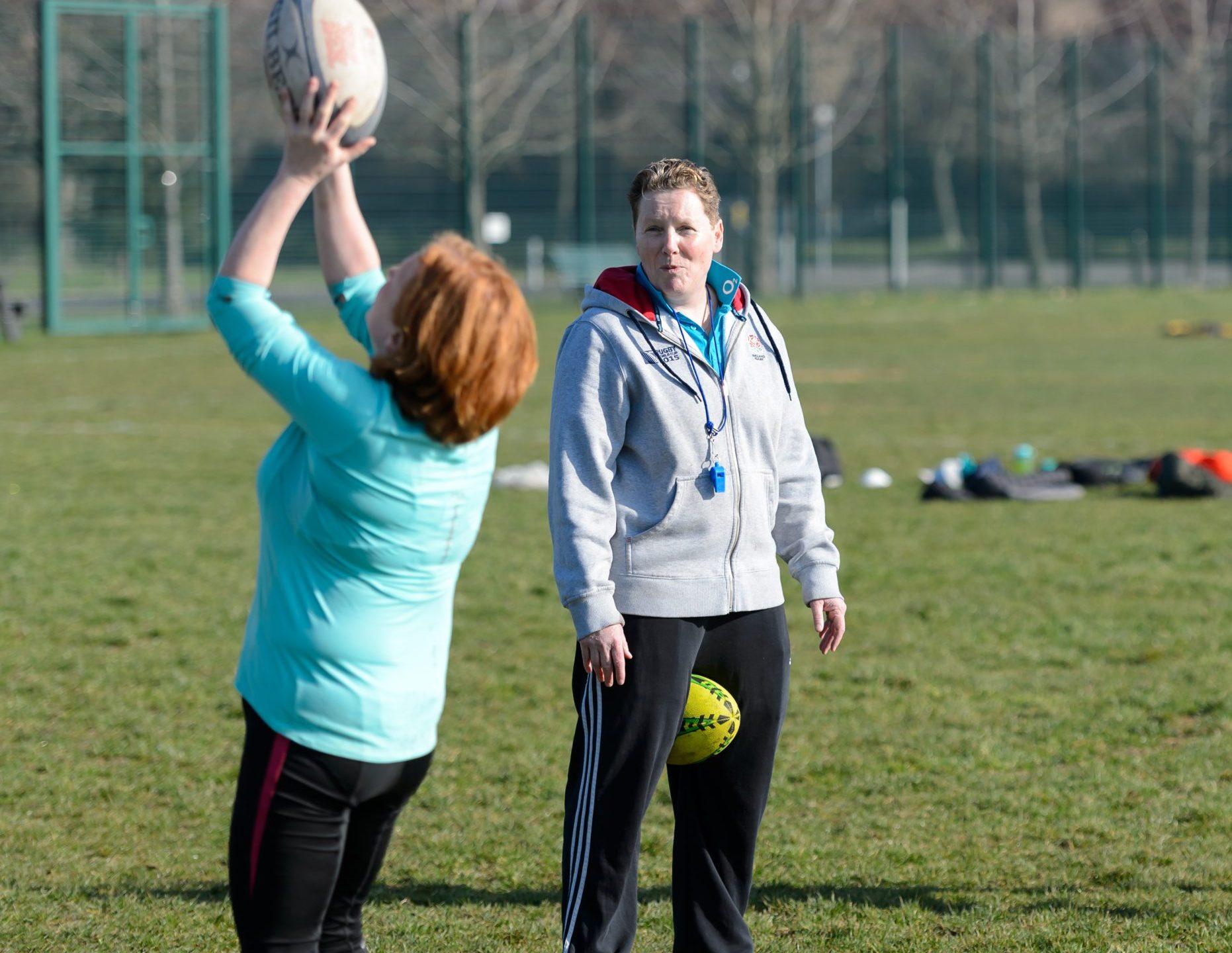 A white female rugby coach with short hair