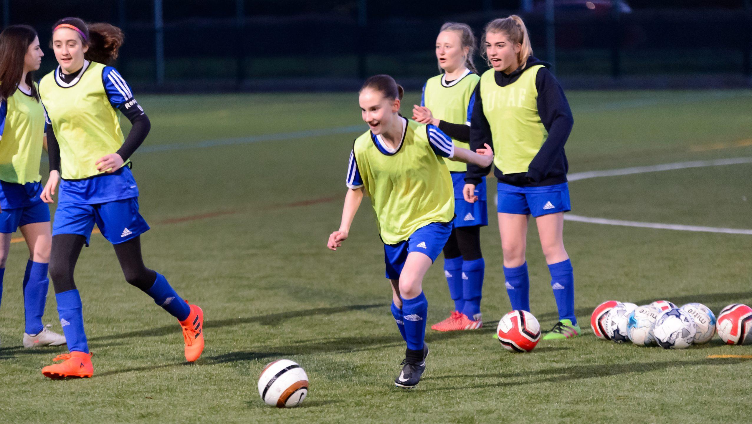 A group of teenage girls playing football for a local club