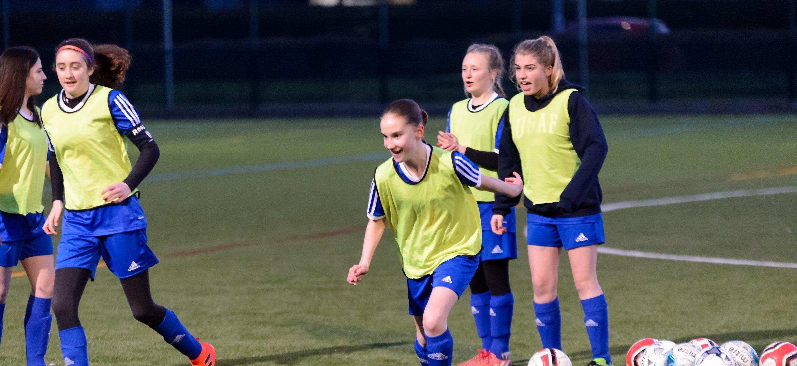 A group of teenage girls playing football for a local club