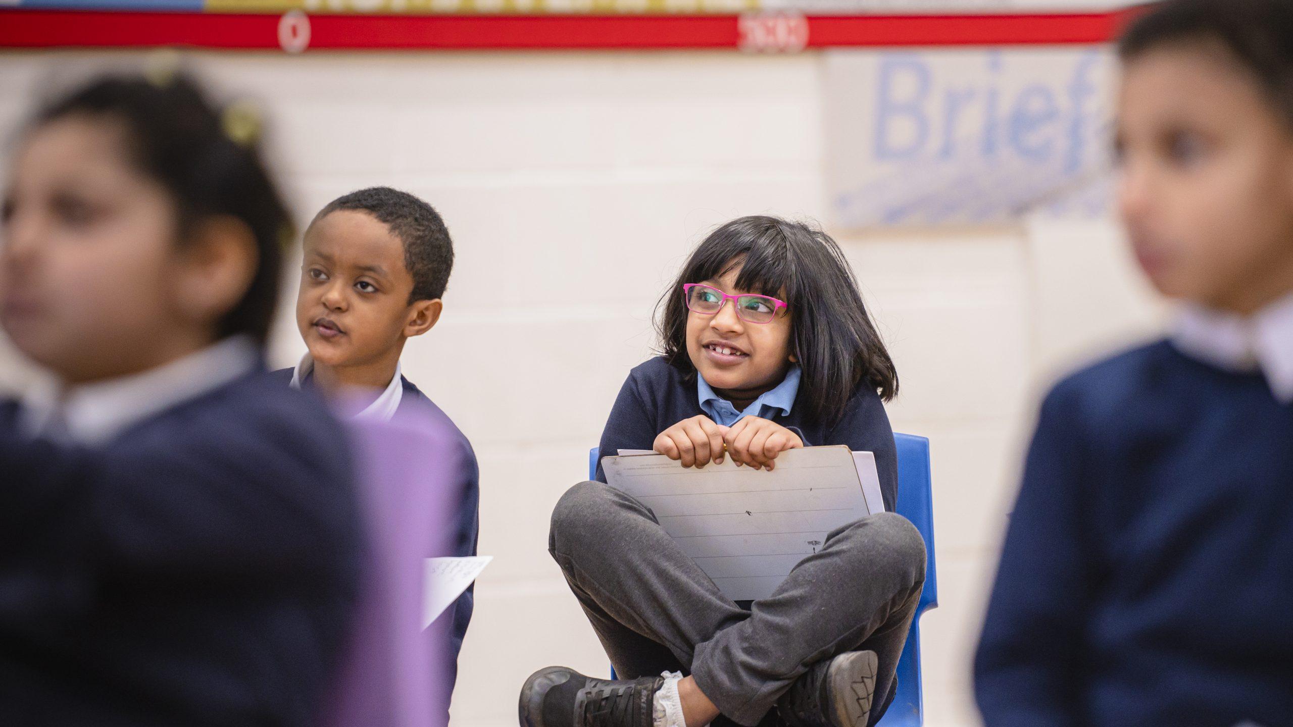 A young South Asian girl sat in primary school