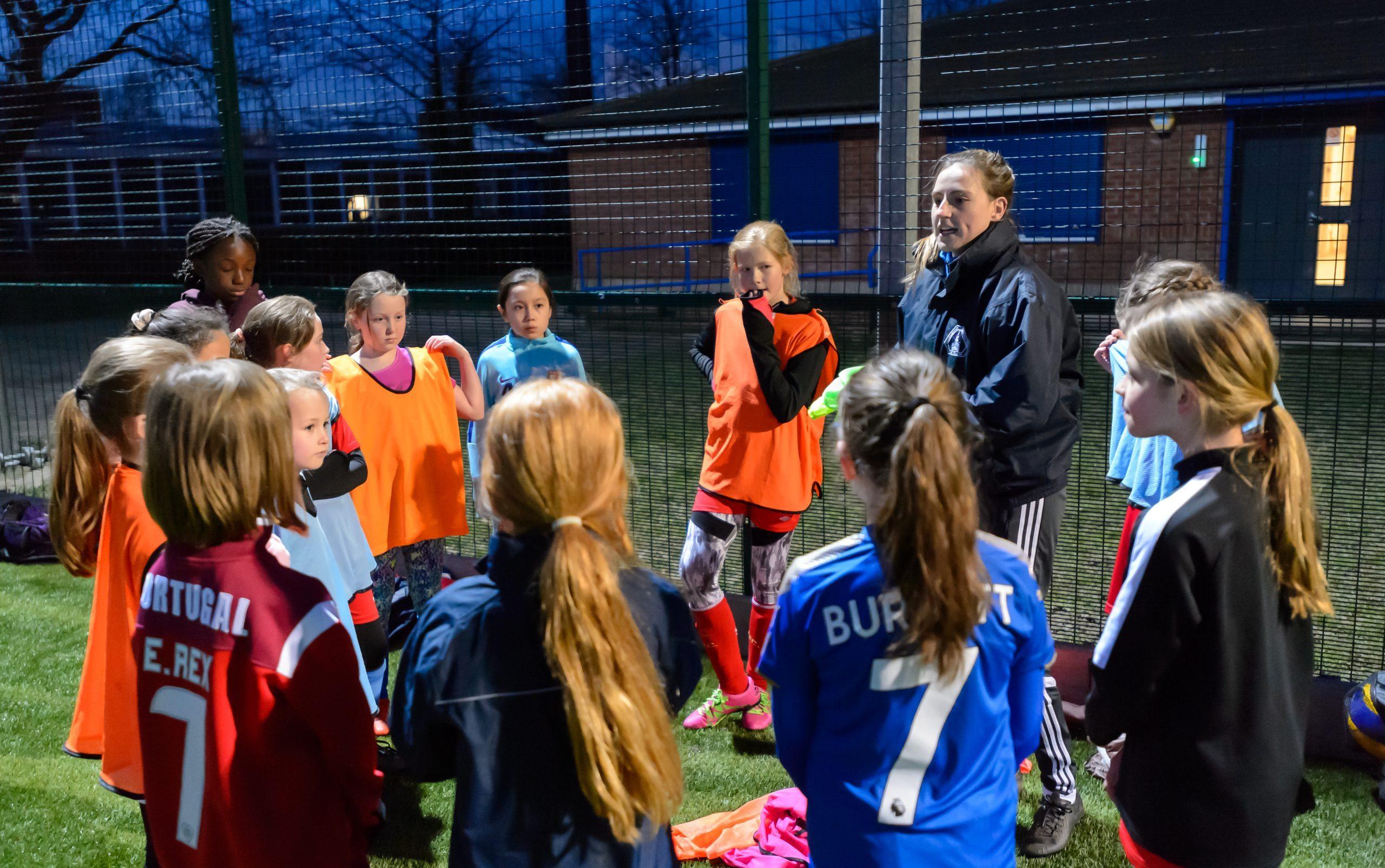 Young girls gathered in a circle after football training