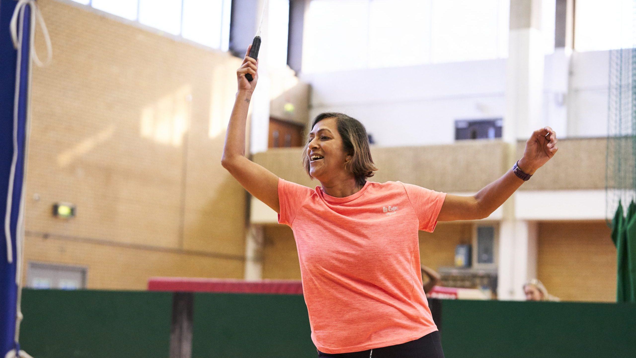 Woman aged 50-60 playing badminton