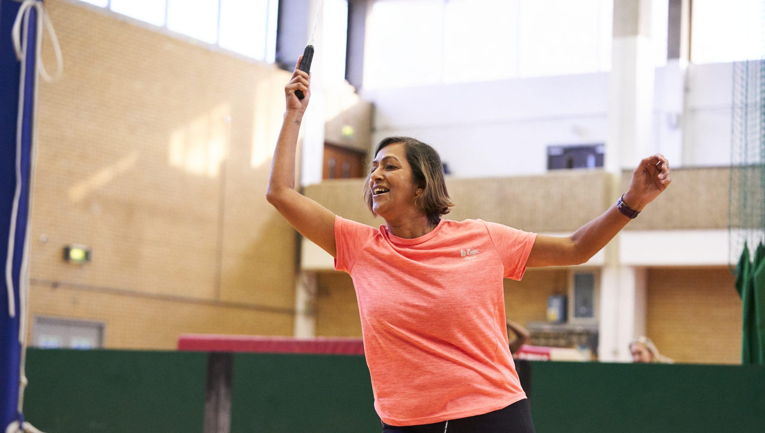 Woman aged 50-60 playing badminton