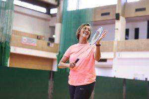 Woman aged 50-55 playing badminton