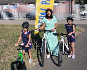 A south Asian mum and her two daughters with their bikes