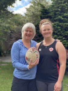 Ellie and Ali posing with a rugby ball