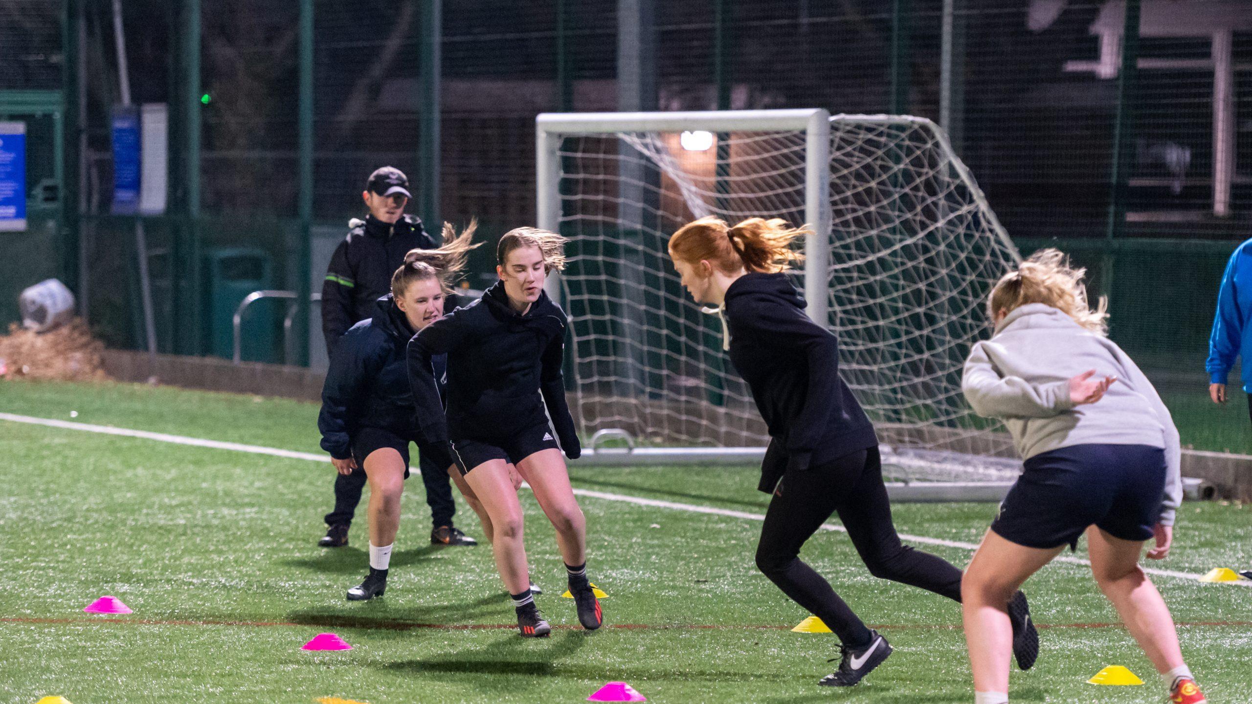 A group of women and girls playing football