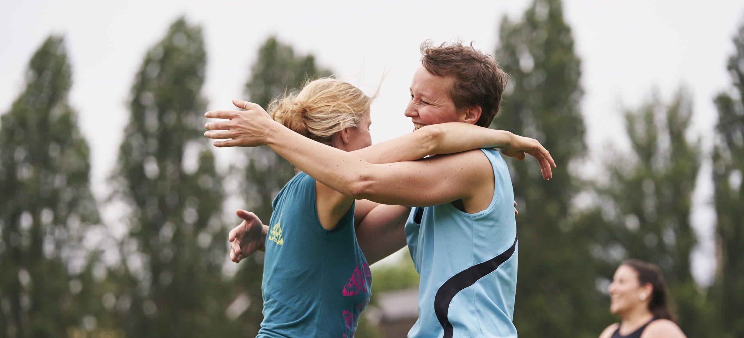 Two women hugging after scoring a winning goal