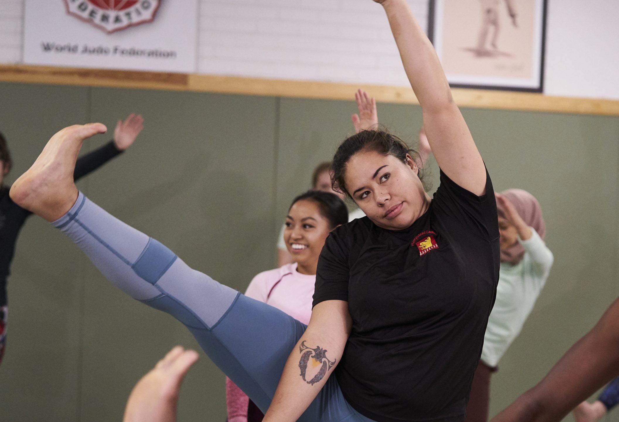 Mixed race woman aged 25-30 doing a yoga class