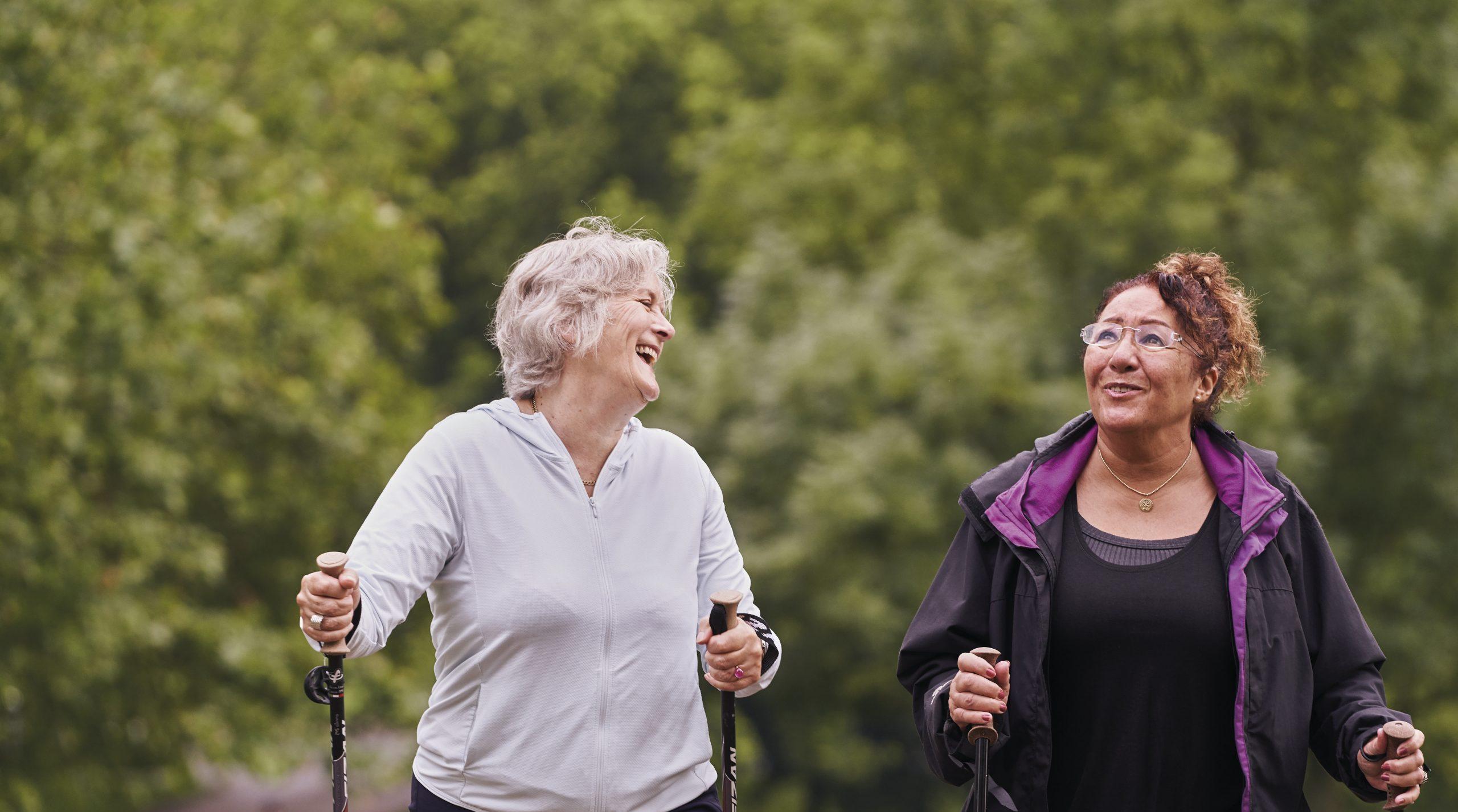 Two women aged 55-70 walking in the park