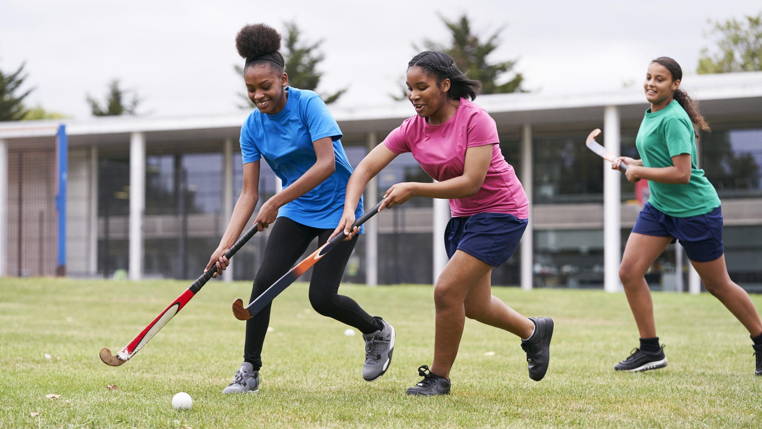 Teenage girls playing hockey