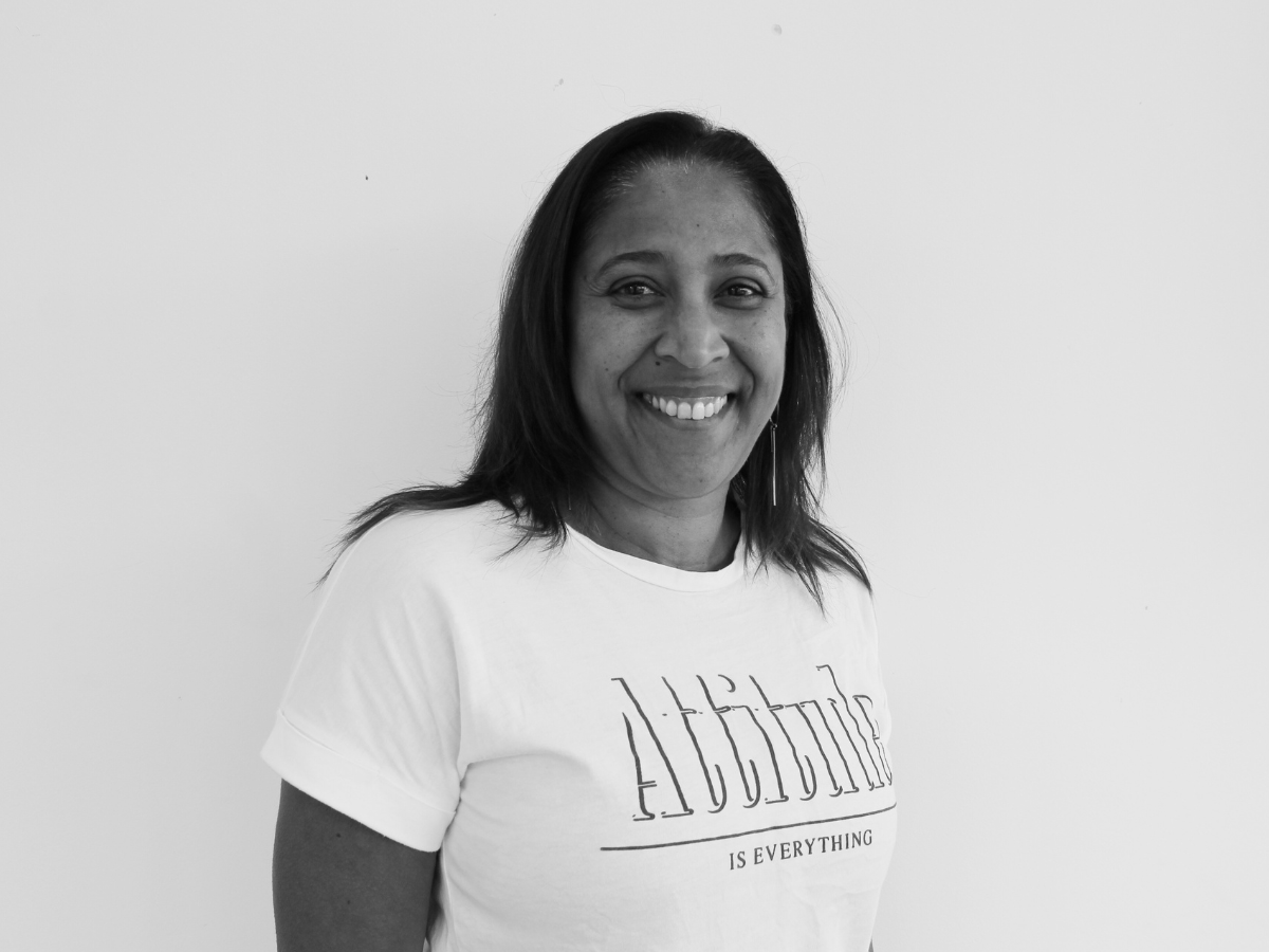 Marie, a mixed race woman with brown hair, smiling