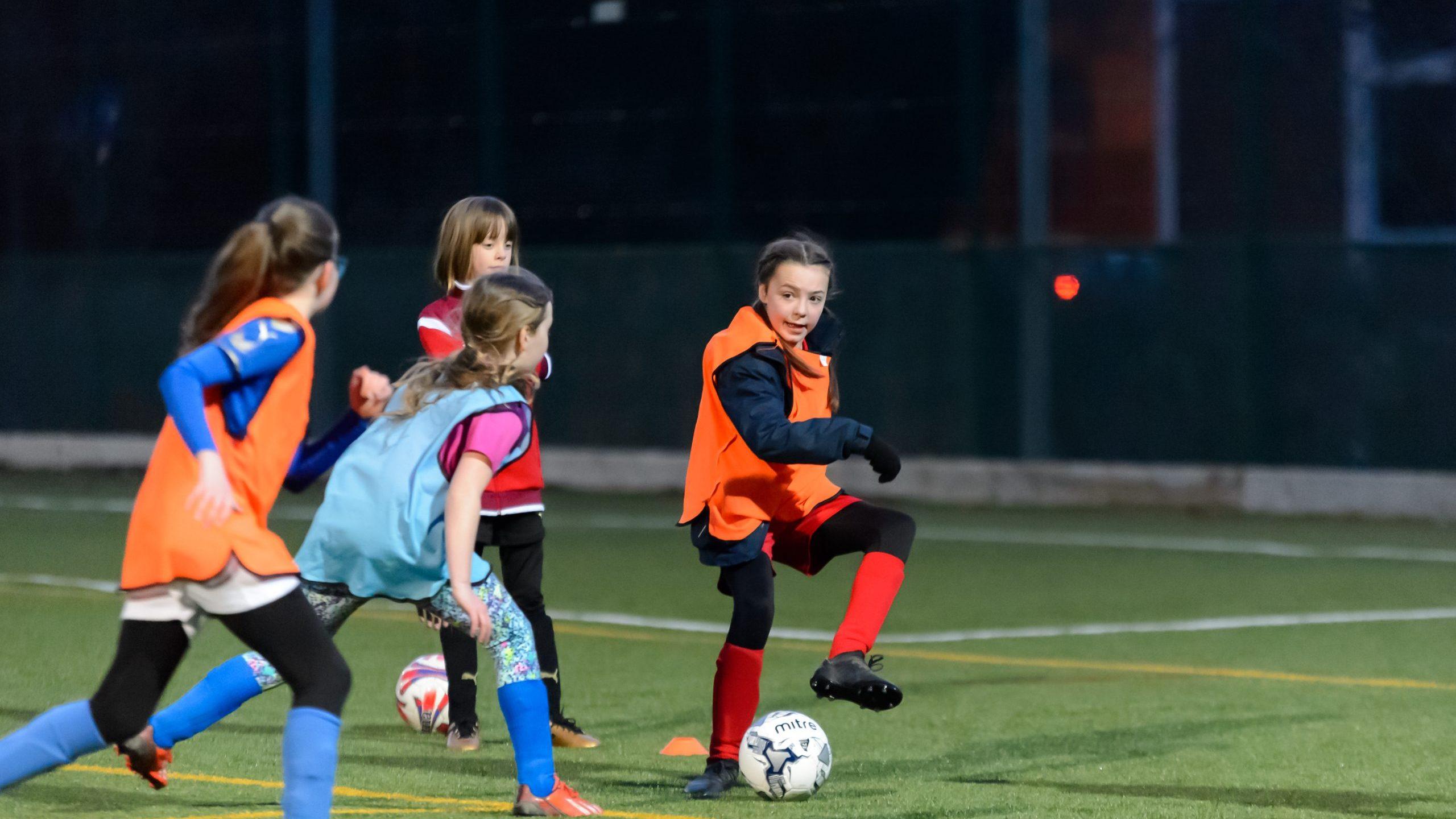 Young girls playing football