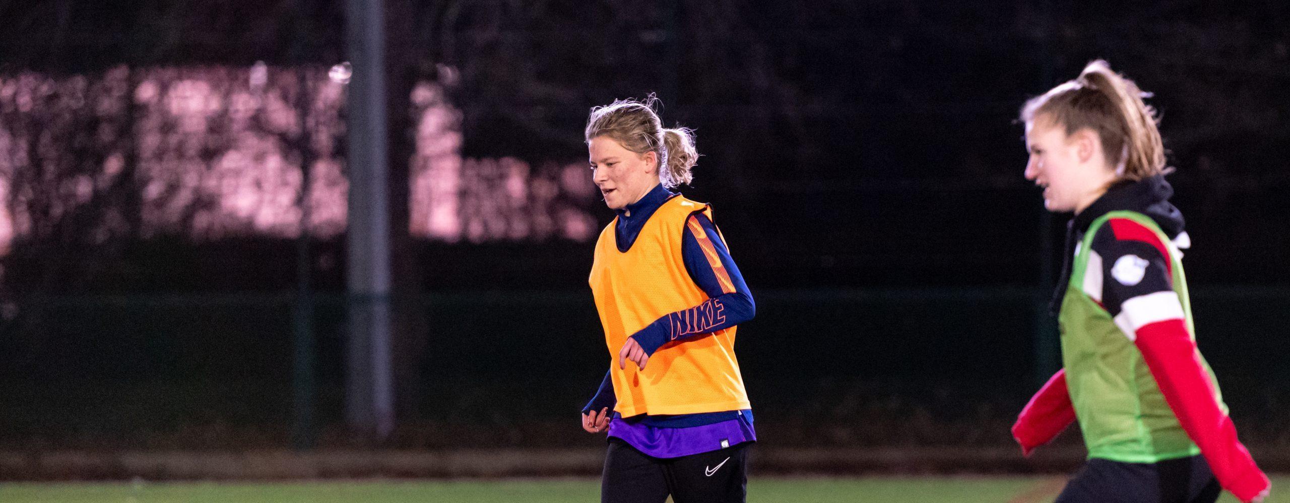 Two young women playing football