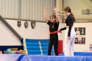 Two girls practicing gymnastics skills