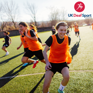 girls running on the football field