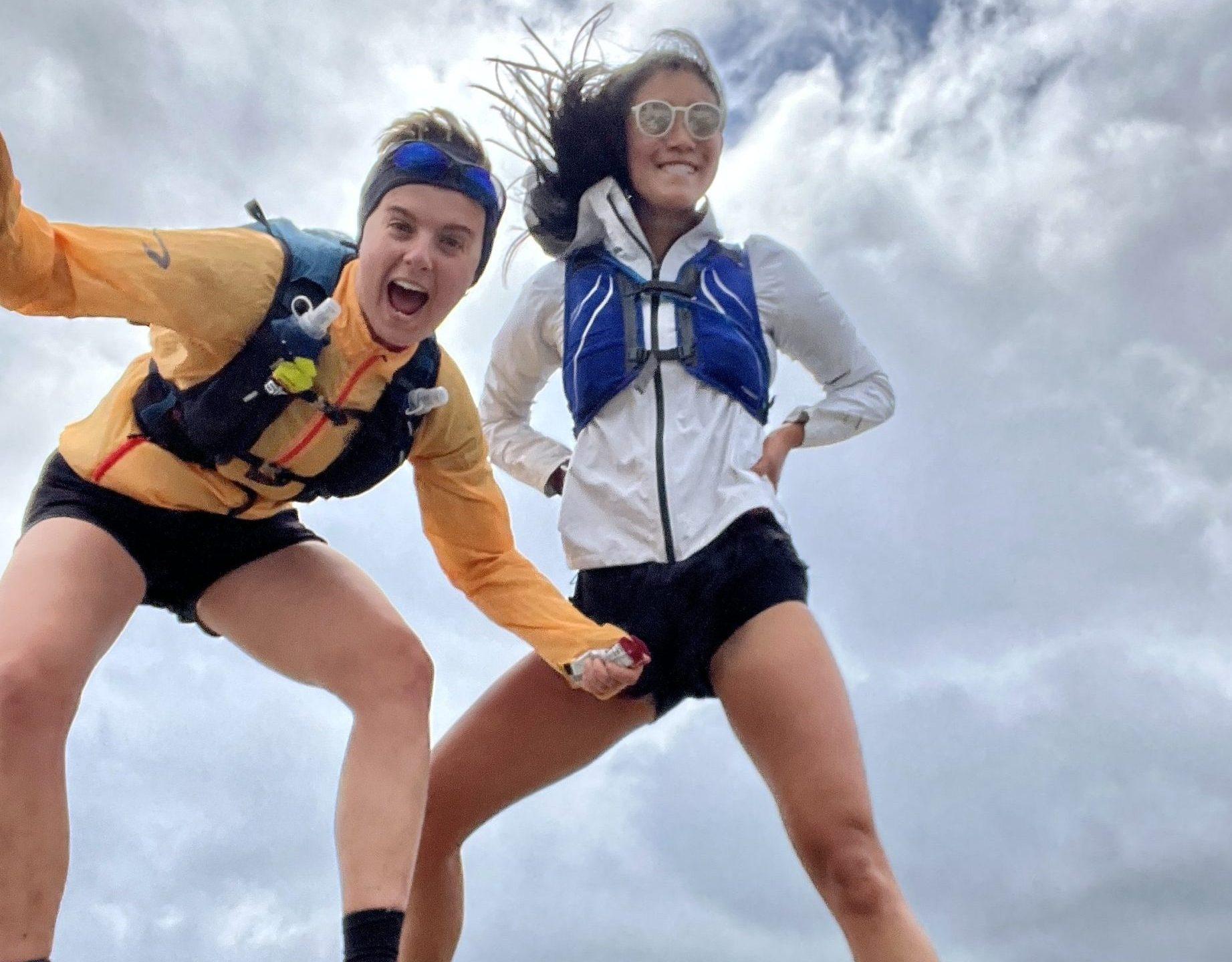 Robin and Caroline in their long distance running kit posing on top of a hill