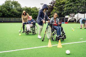 A teenage girl with South Asian Heritage playing wheelchair hockey