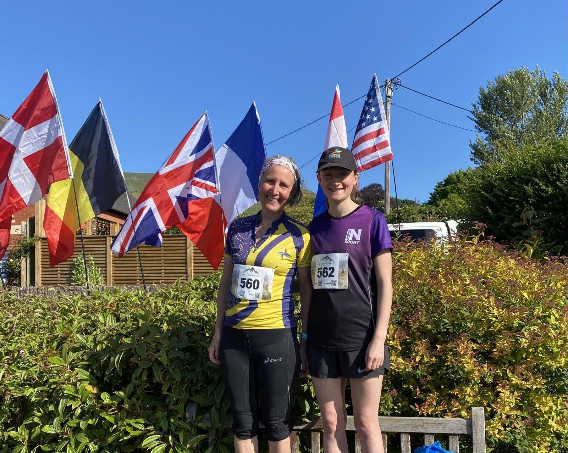 A mum and daughter smiling before a running race