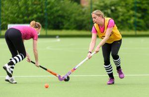 Women playing hockey