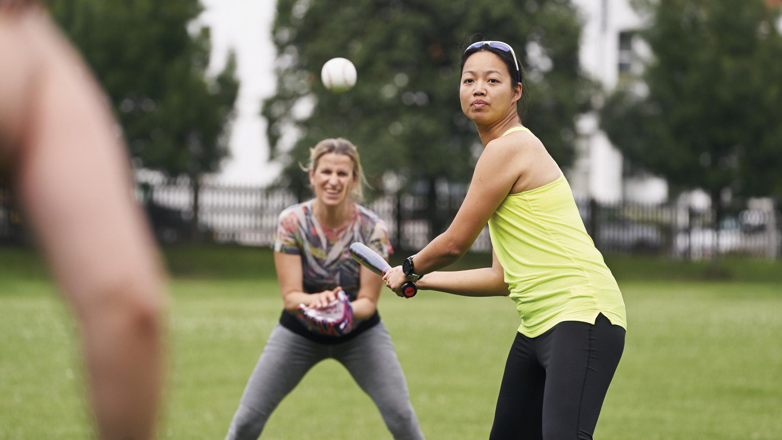 A group of women playing rounders