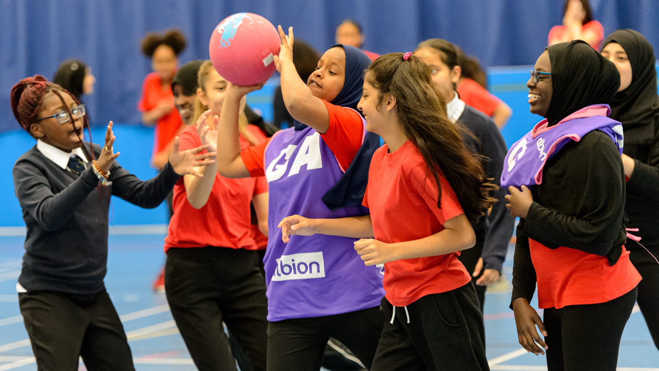 A group of teenage girls playing basketball