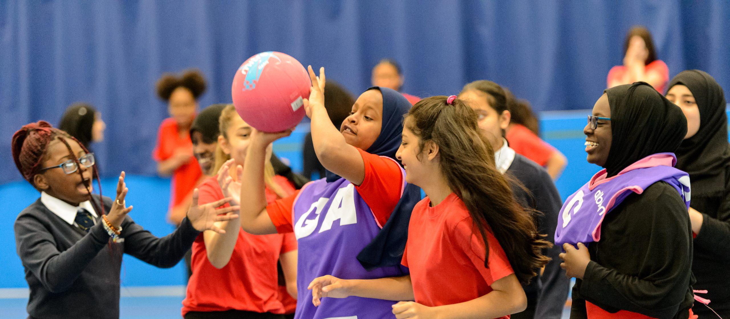 A group of teenage girls playing basketball