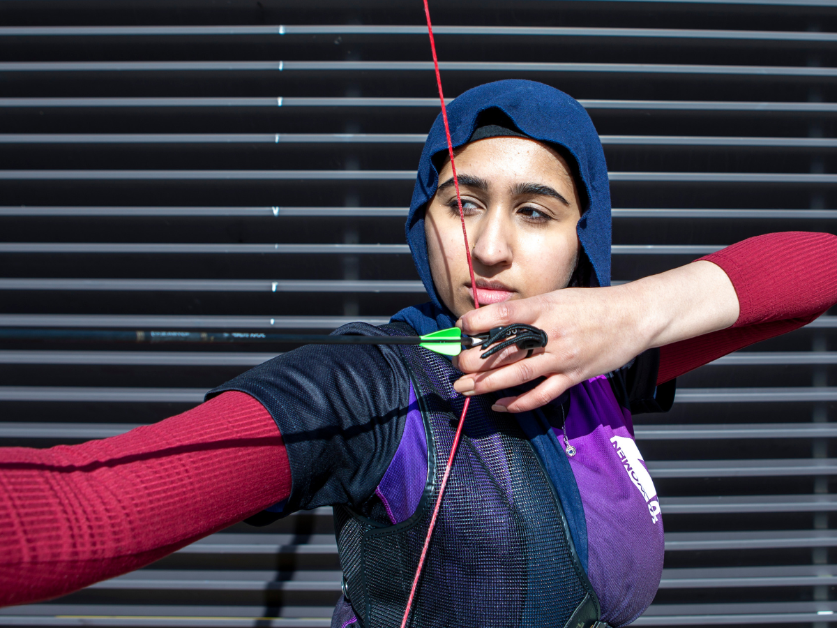 Nafeesa, a young muslim woman, using a bow and arrow